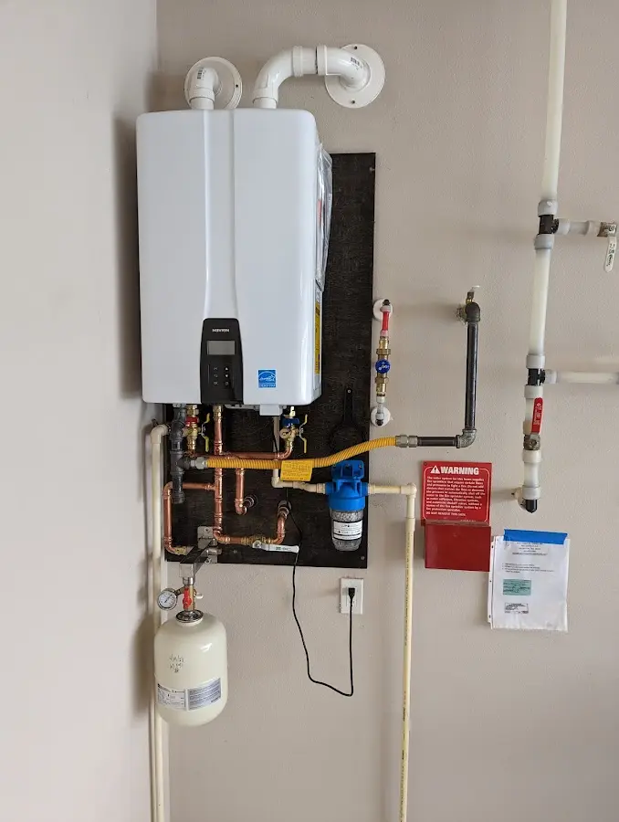 Professional plumber installing copper piping in a Seaside home